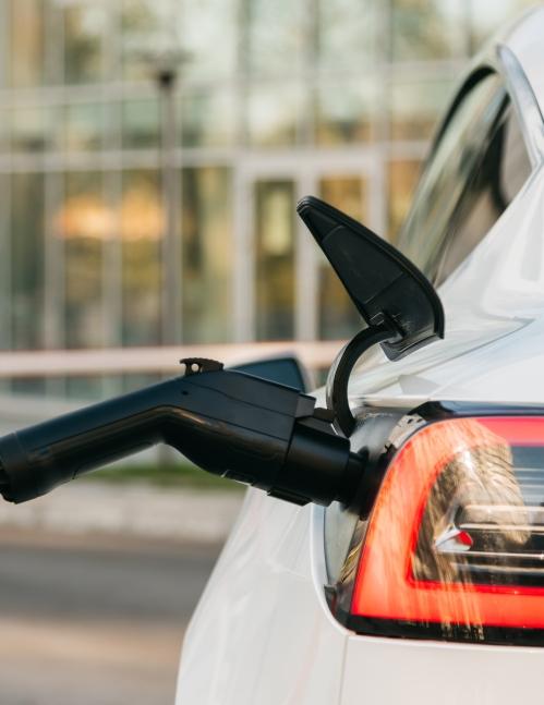 Electric vehicle plugged into charger