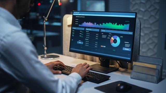 A man typing at a computer with various graphs showing Pulse Cx