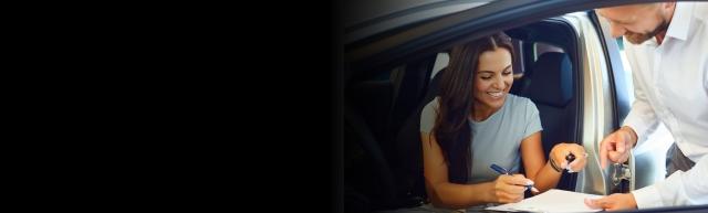Woman signing for car