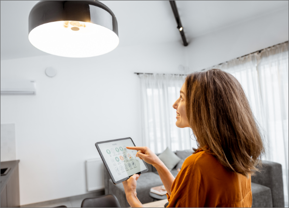 woman adjusting brightness of a light in a living room