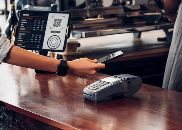 Person scanning phone on cash register