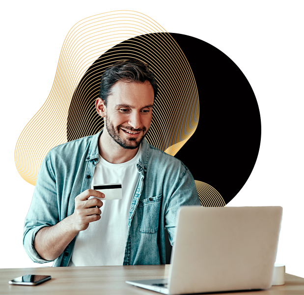 Man holding credit card in front of laptop 