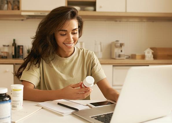 Woman on the computer with a prescription