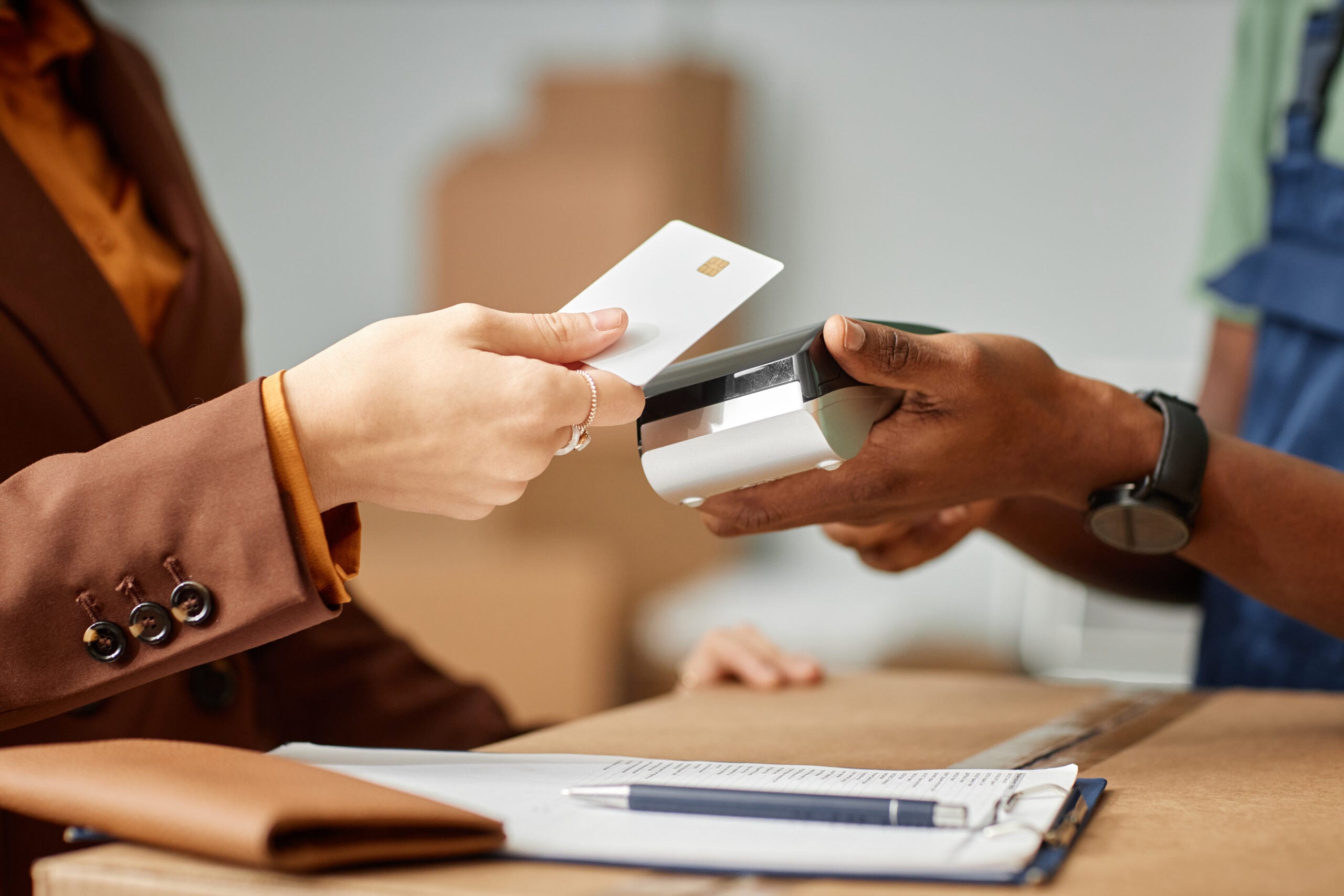 woman paying with debit card at point-of-sale