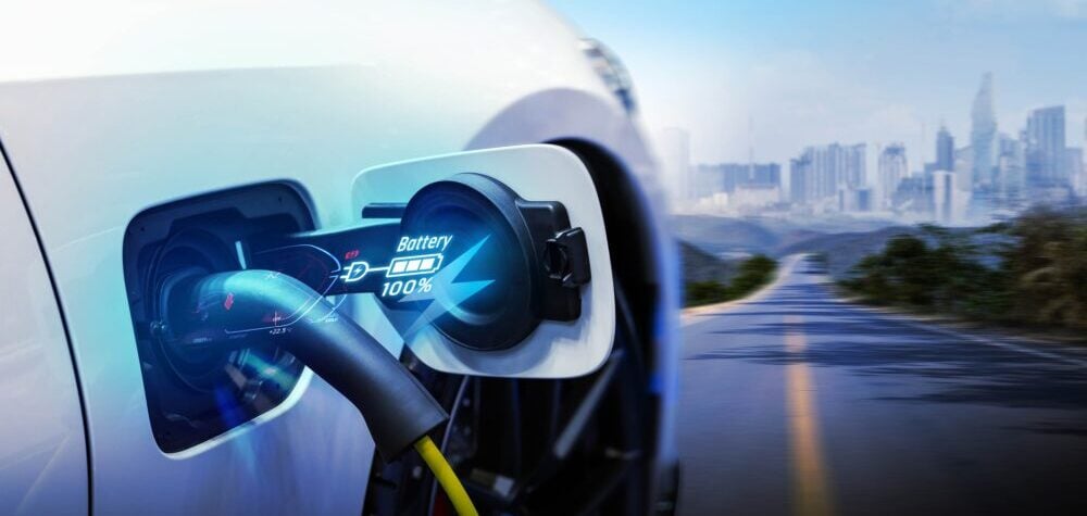 Power cable pump plug in charging power to electric vehicle EV car.