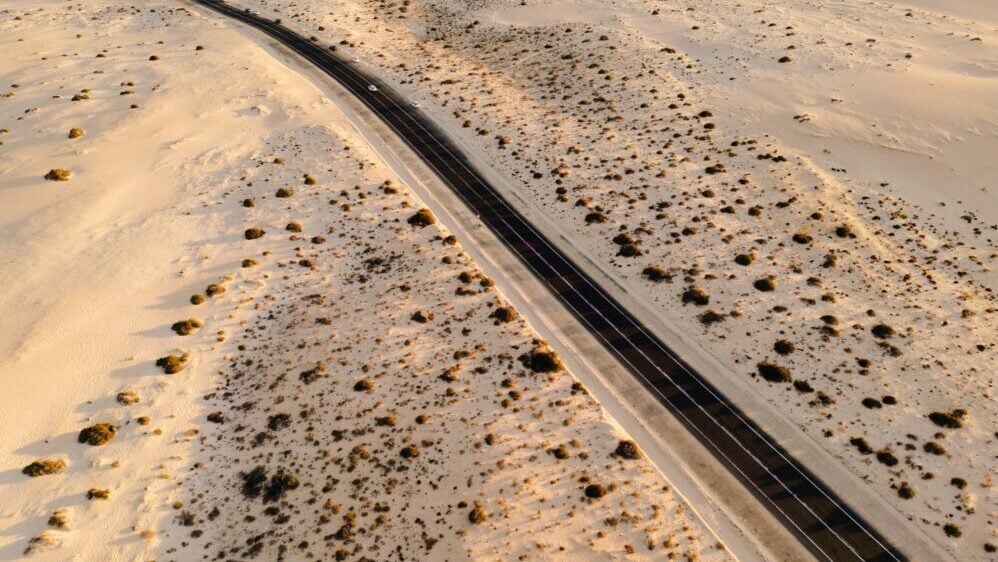 Spain, Canary Islands, Fuerteventura, Corralejo National Park, road running through sand dunes